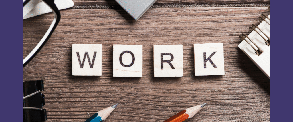 Work spelt out on a desk using tiles with usual work related paraphernalia such as pencils, notepads in shot