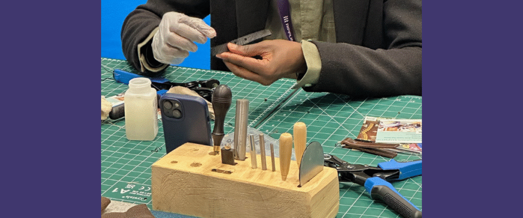 A person changing a piece of leather into a creative keyring